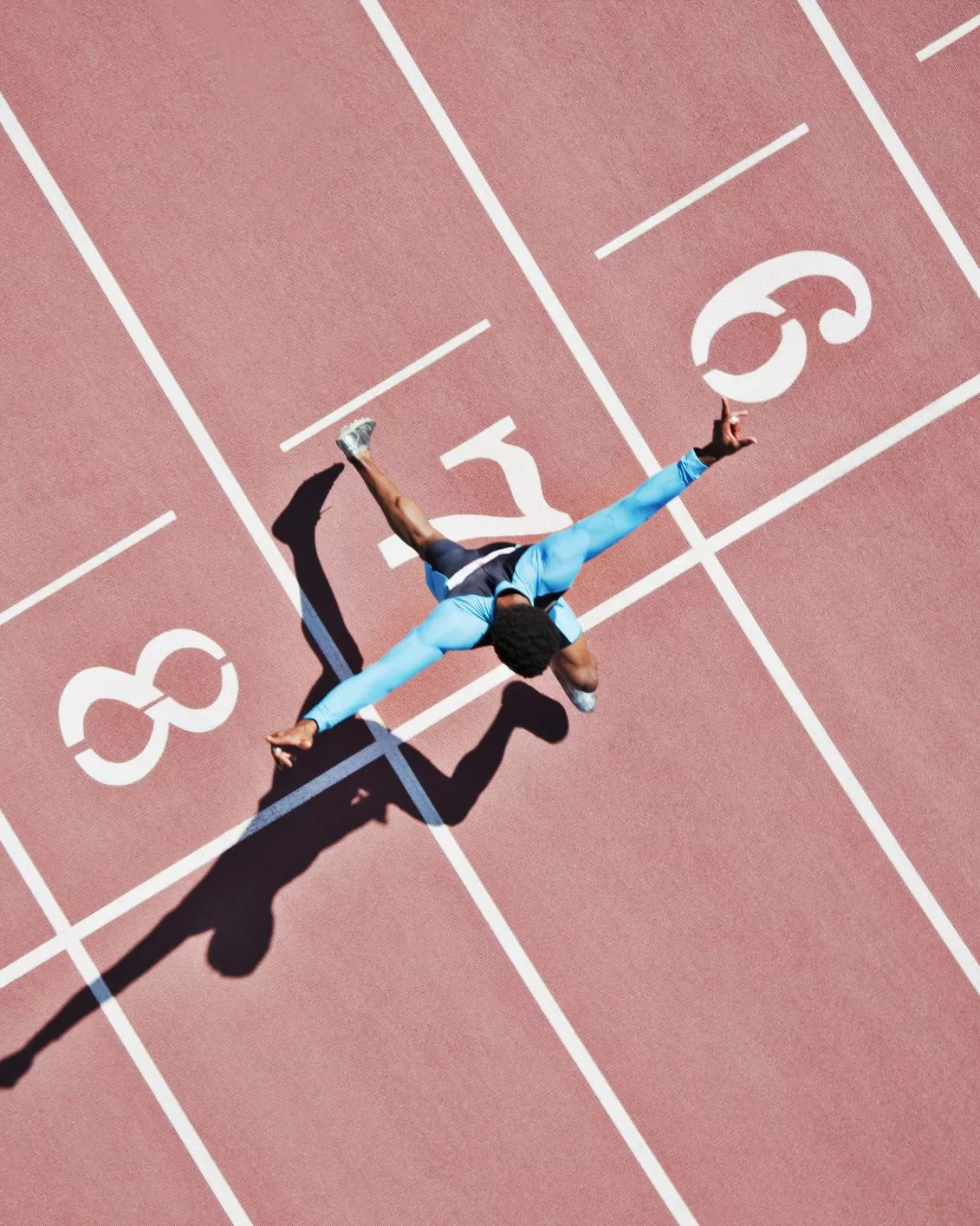 Runner crossing finishing line on track
